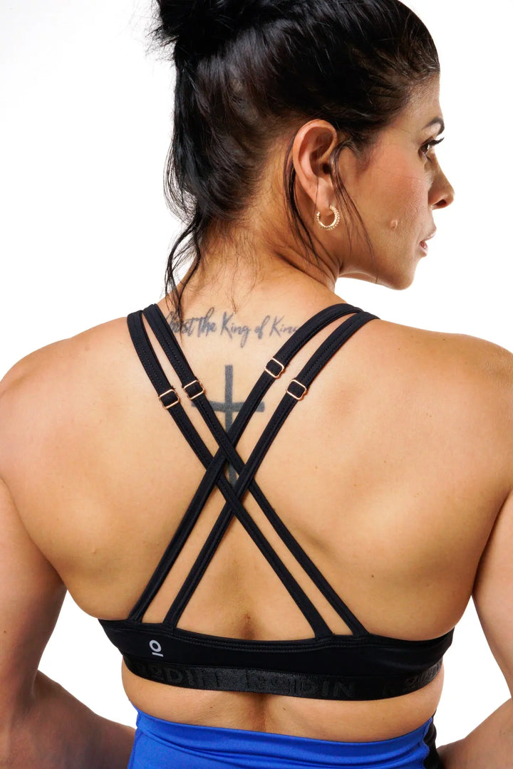 Woman wearing the Nola sport bra adjustable of color black#color_black