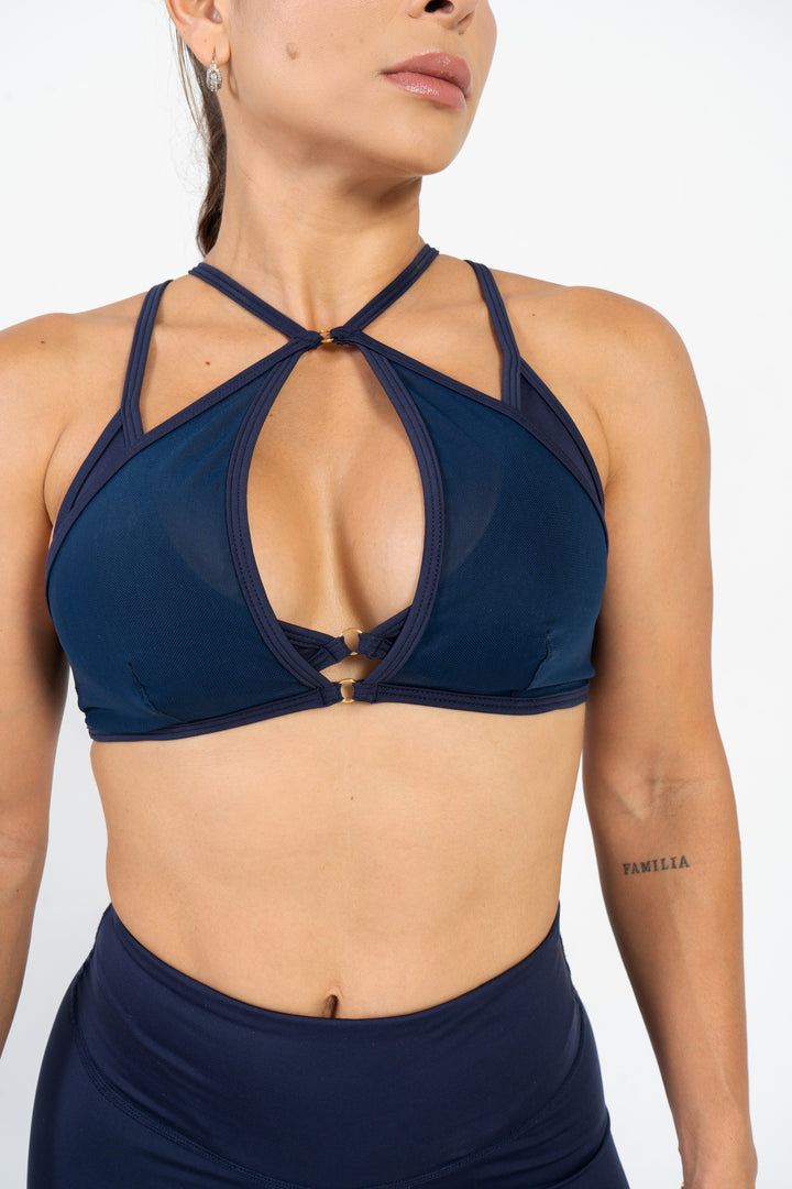 Navy blue sports bra and shorts on a person against a white background #color_dark-iris