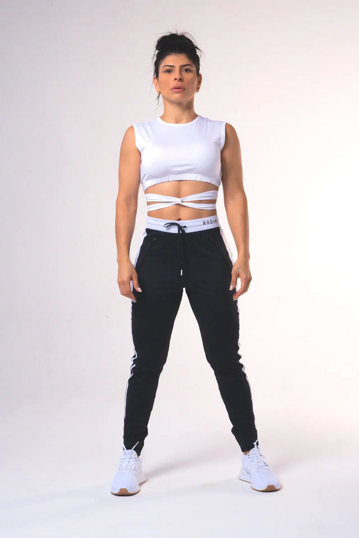 Woman wearing the Nikkie crop top functional of color white#color_white
